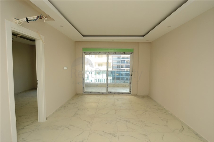 شقة بسعر مناسب ضمن مجمع جديد في منطقة محمودلار -ألانيا