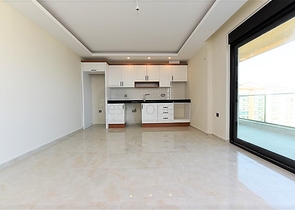 اول صف على البحر - شقة غرفتين وصالة طابق مرتفع -- مهموتلار / الانيا 