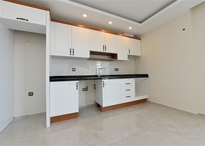 اول صف على البحر - شقة غرفتين وصالة طابق مرتفع -- مهموتلار / الانيا 