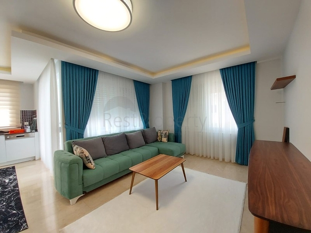 بسعر مناسب - شقة مؤثثة من تصميم 1+2 غرفتين وصالة - ضمن مجمع سكني - في مهموتلار / الانيا 