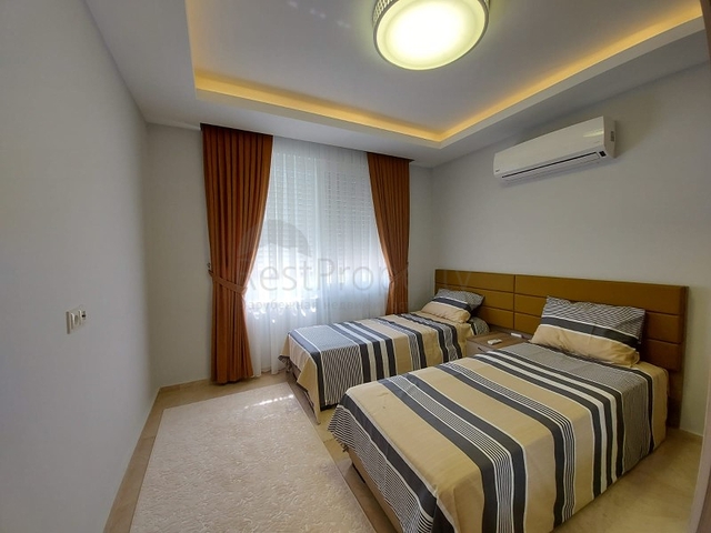 بسعر مناسب - شقة مؤثثة من تصميم 1+2 غرفتين وصالة - ضمن مجمع سكني - في مهموتلار / الانيا 