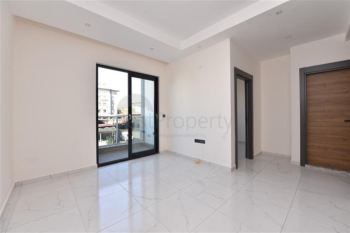 سعر مناسب - شقة غرفة وصالة جديدة -ضمن مجمع سكني في موقع ممتاز - اوبا / الانيا 